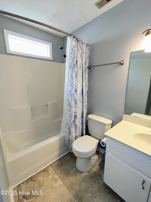 bathroom featuring a textured ceiling, toilet, vanity, visible vents, and shower / bath combo with shower curtain