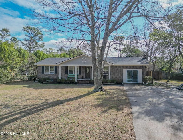 single story home featuring a front yard, fence, and brick siding