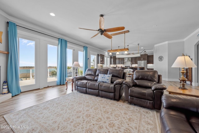 living room featuring ceiling fan, wood finished floors, recessed lighting, and crown molding