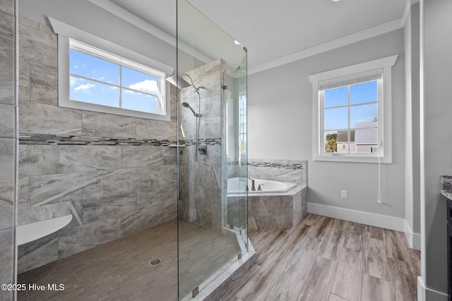 full bath with a bath, ornamental molding, baseboards, walk in shower, and wood finished floors