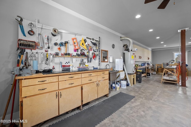 interior space featuring gas water heater, concrete flooring, a workshop area, ceiling fan, and recessed lighting