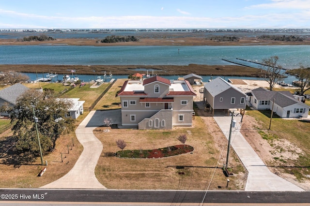 birds eye view of property with a water view and a residential view