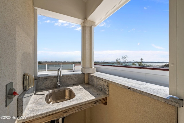 view of patio with an outdoor kitchen and a sink