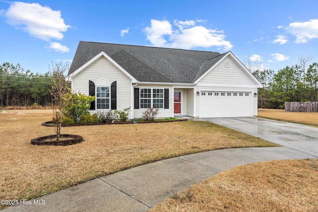 ranch-style home featuring concrete driveway, a garage, a front yard, and roof with shingles