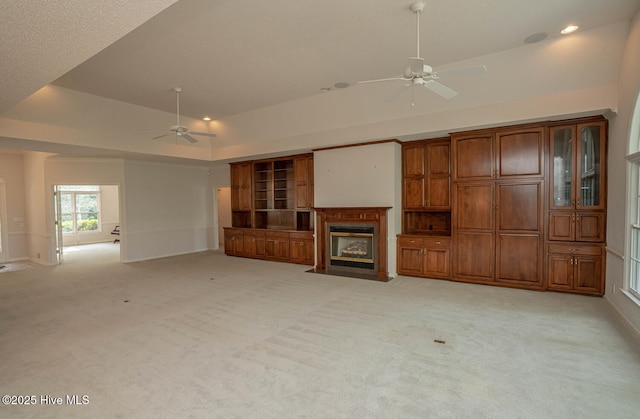 234 Crooked Gulley Cir, Sunset Beach, NC 28468 - unfurnished living room with ceiling fan, light colored carpet, a fireplace with flush hearth, recessed lighting, and a raised ceiling
