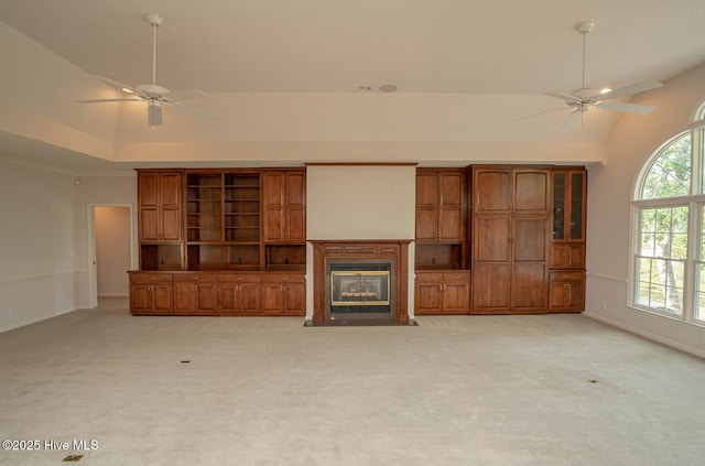 234 Crooked Gulley Cir, Sunset Beach, NC 28468 - unfurnished living room featuring ceiling fan, lofted ceiling, light colored carpet, baseboards, and a fireplace with flush hearth