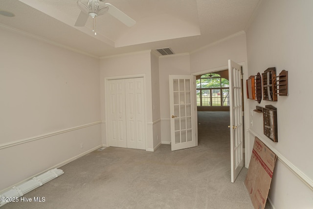 234 Crooked Gulley Cir, Sunset Beach, NC 28468 - unfurnished bedroom featuring french doors, light carpet, crown molding, a closet, and a ceiling fan