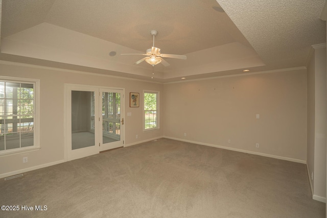 234 Crooked Gulley Cir, Sunset Beach, NC 28468 - carpeted empty room with a raised ceiling, ceiling fan, baseboards, healthy amount of natural light, and a textured ceiling
