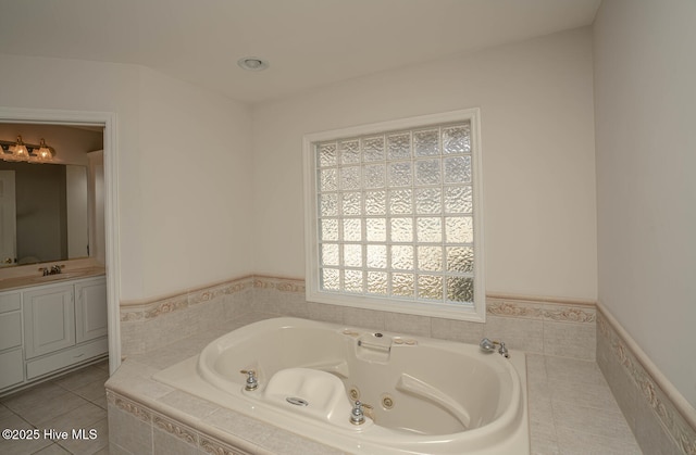234 Crooked Gulley Cir, Sunset Beach, NC 28468 - bathroom featuring a jetted tub, vanity, and a wainscoted wall