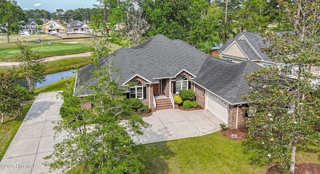 234 Crooked Gulley Cir, Sunset Beach, NC 28468 - view of front of property featuring a shingled roof, brick siding, a garage, driveway, and a front yard