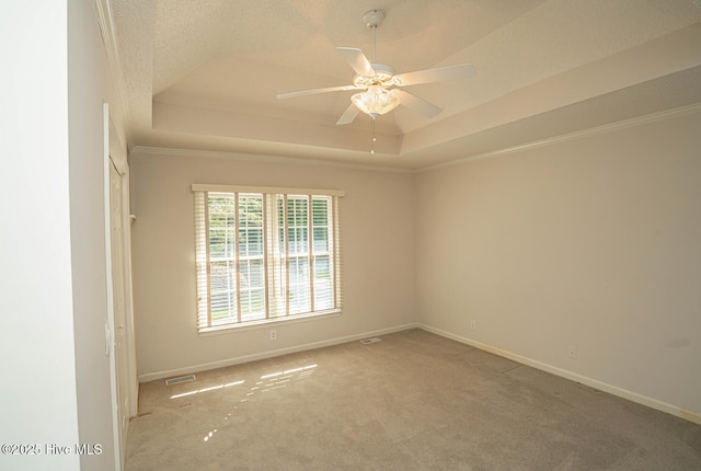 234 Crooked Gulley Cir, Sunset Beach, NC 28468 - carpeted spare room with a tray ceiling, a ceiling fan, baseboards, and crown molding