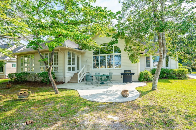 234 Crooked Gulley Cir, Sunset Beach, NC 28468 - back of house with a patio and a lawn