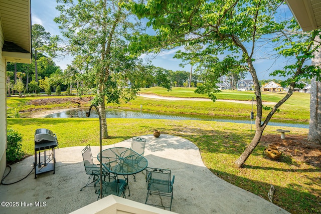 234 Crooked Gulley Cir, Sunset Beach, NC 28468 - view of patio / terrace with a water view, outdoor dining space, and a grill
