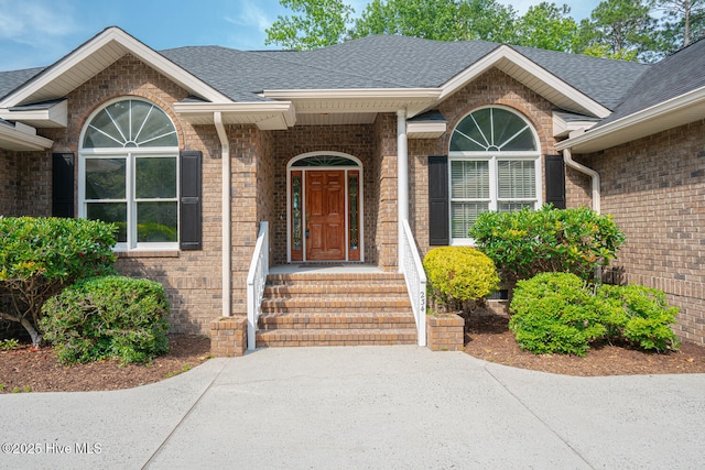 234 Crooked Gulley Cir, Sunset Beach, NC 28468 - entrance to property featuring a shingled roof and brick siding