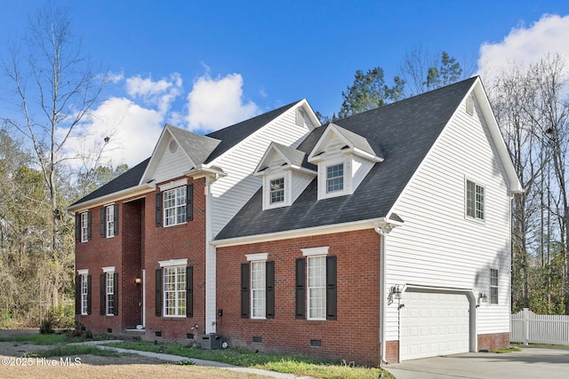 view of front of home with brick siding, an attached garage, fence, crawl space, and driveway