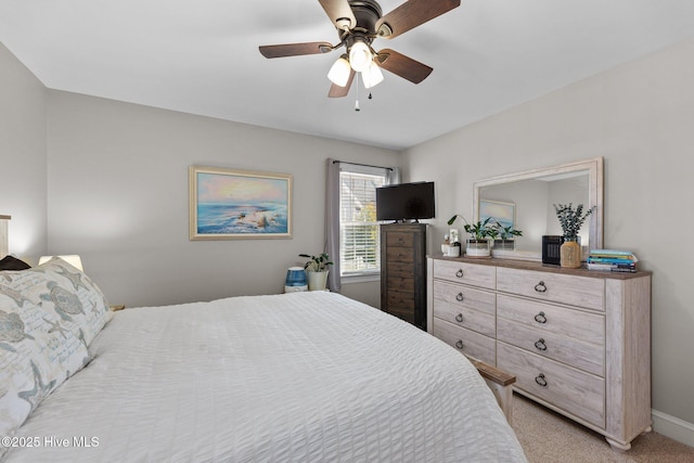 bedroom featuring baseboards, a ceiling fan, and light colored carpet