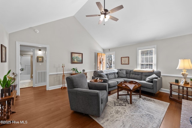 living room with ceiling fan, high vaulted ceiling, wood finished floors, visible vents, and baseboards