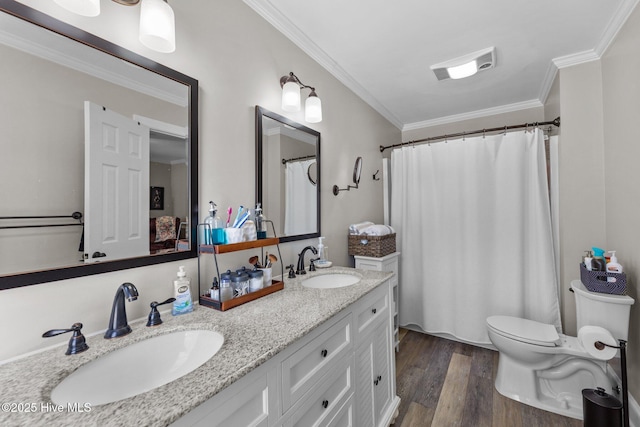 bathroom featuring ornamental molding, wood finished floors, a sink, and toilet