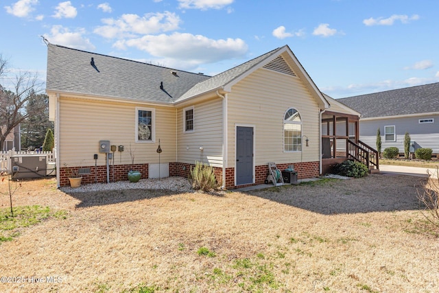 back of property featuring a shingled roof, crawl space, fence, and central AC unit