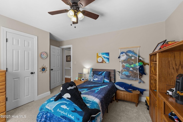 carpeted bedroom with baseboards and a ceiling fan