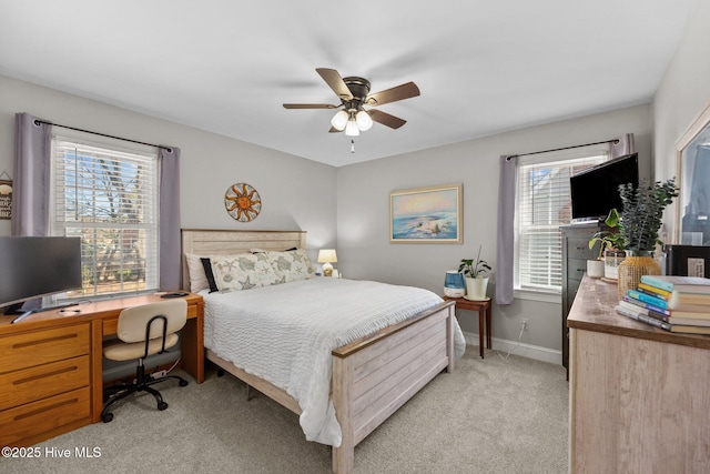 bedroom featuring light carpet, ceiling fan, and baseboards