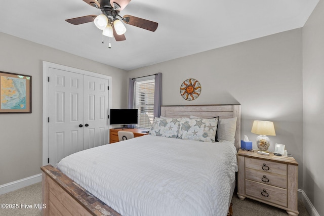 carpeted bedroom featuring a ceiling fan, a closet, and baseboards