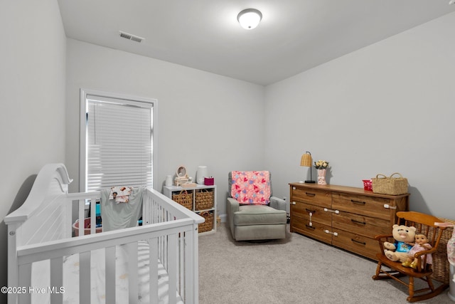 carpeted bedroom with a crib and visible vents