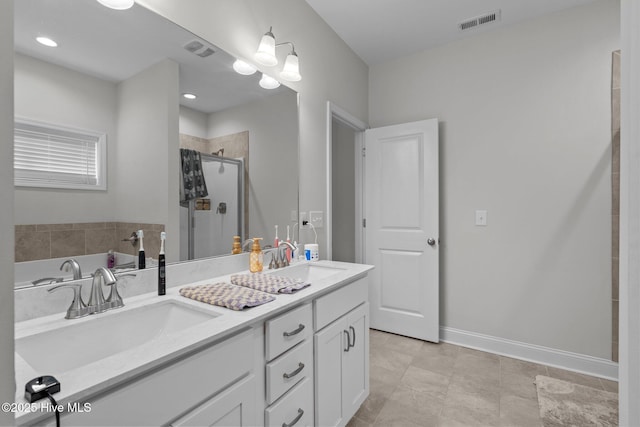 full bath with double vanity, a stall shower, a sink, and visible vents