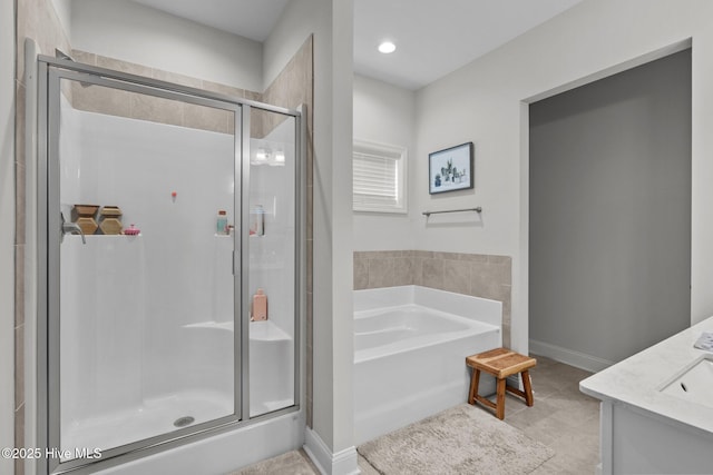 bathroom with baseboards, tile patterned floors, a garden tub, vanity, and a shower stall