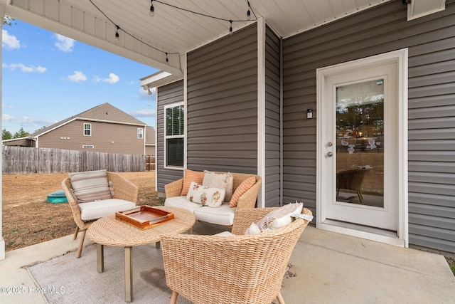 view of patio featuring fence and an outdoor hangout area