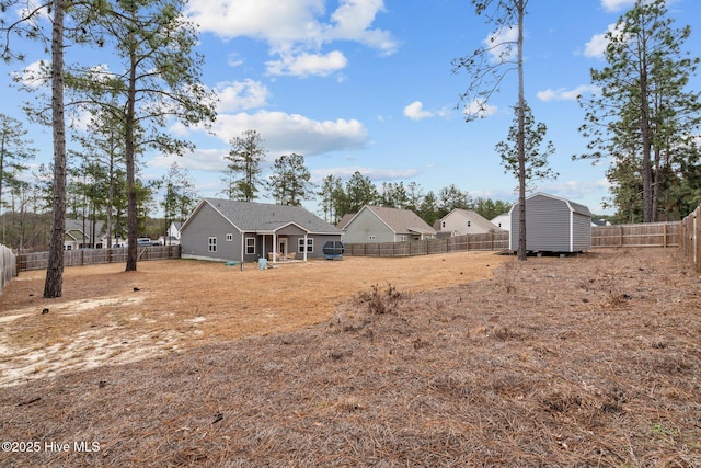 view of yard featuring an outbuilding and a fenced backyard