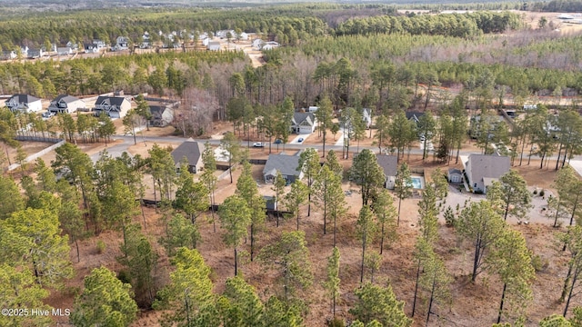 birds eye view of property featuring a view of trees