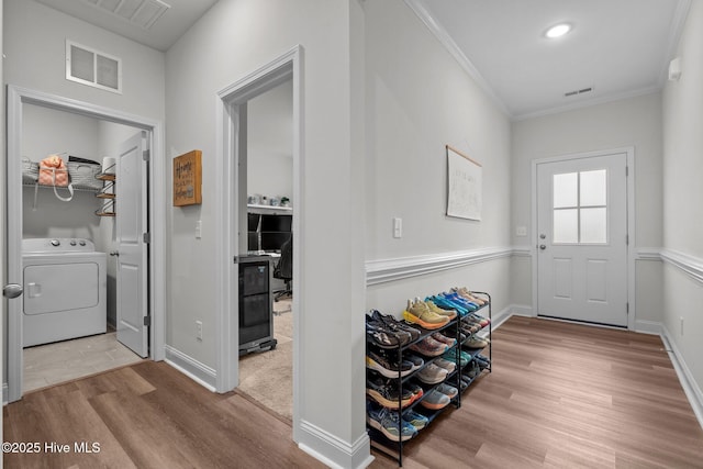 interior space featuring visible vents, wood finished floors, and washer / dryer