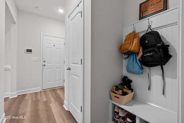 mudroom featuring baseboards and light wood finished floors