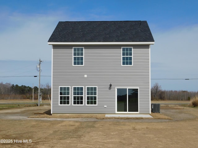 back of house with central air condition unit