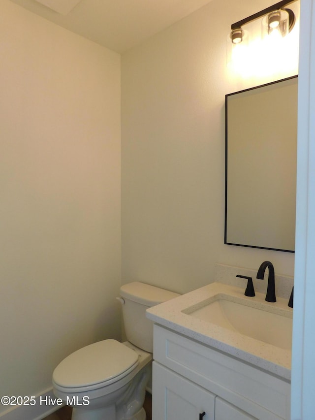 bathroom with toilet and vanity