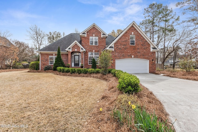 traditional home featuring a garage, brick siding, driveway, and roof with shingles