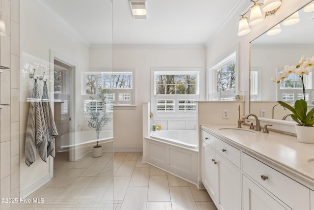 bathroom with tile patterned flooring, crown molding, baseboards, a garden tub, and vanity