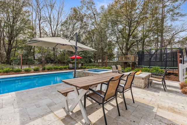 view of swimming pool featuring a patio, a trampoline, a fenced backyard, a fenced in pool, and an in ground hot tub