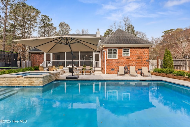 view of swimming pool with a fenced in pool, fence, a sunroom, an in ground hot tub, and a patio