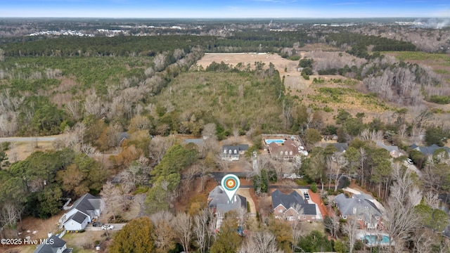 birds eye view of property with a forest view