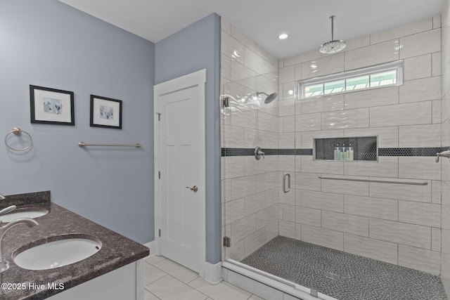 full bath with a shower stall, vanity, and tile patterned floors