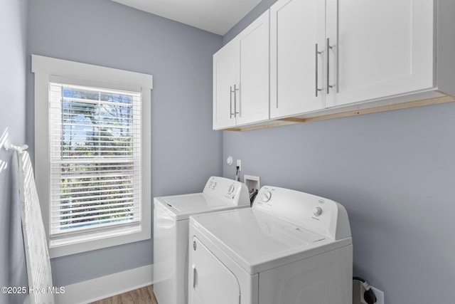 laundry room with washer and dryer, cabinet space, plenty of natural light, and baseboards