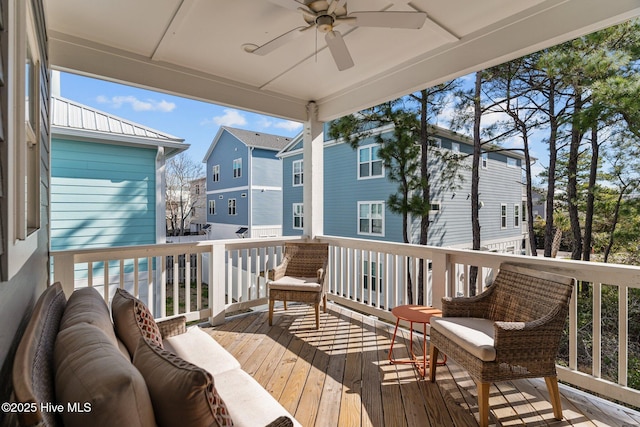 wooden deck with ceiling fan, an outdoor hangout area, and a residential view