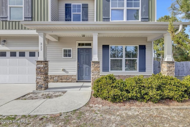 entrance to property with a garage and covered porch