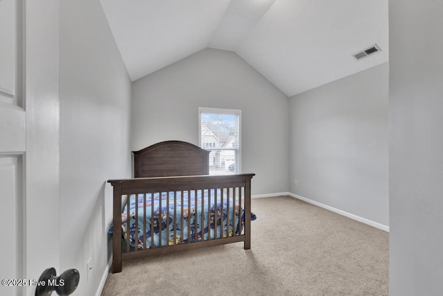 carpeted bedroom with baseboards, visible vents, and vaulted ceiling