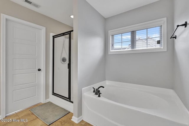 full bathroom featuring a stall shower, tile patterned flooring, visible vents, and a bath