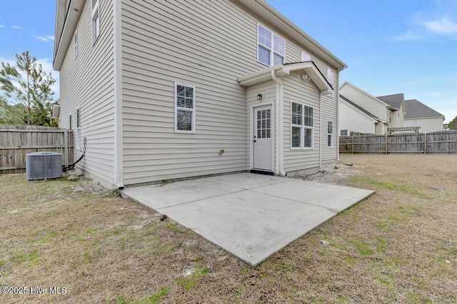 rear view of property with a patio area, a fenced backyard, a lawn, and cooling unit