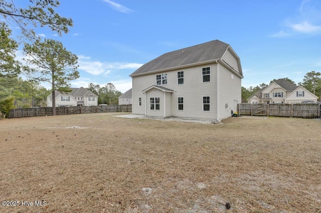 rear view of house featuring a patio area and a fenced backyard