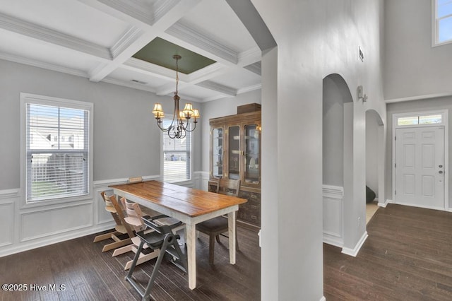 dining room with arched walkways, beamed ceiling, hardwood / wood-style flooring, and a notable chandelier